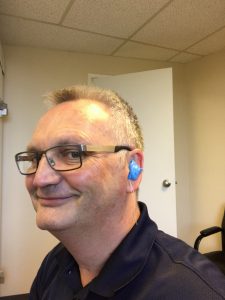Scott Hyde from Fraser Valley Beltone demonstrating how a hearing aid works