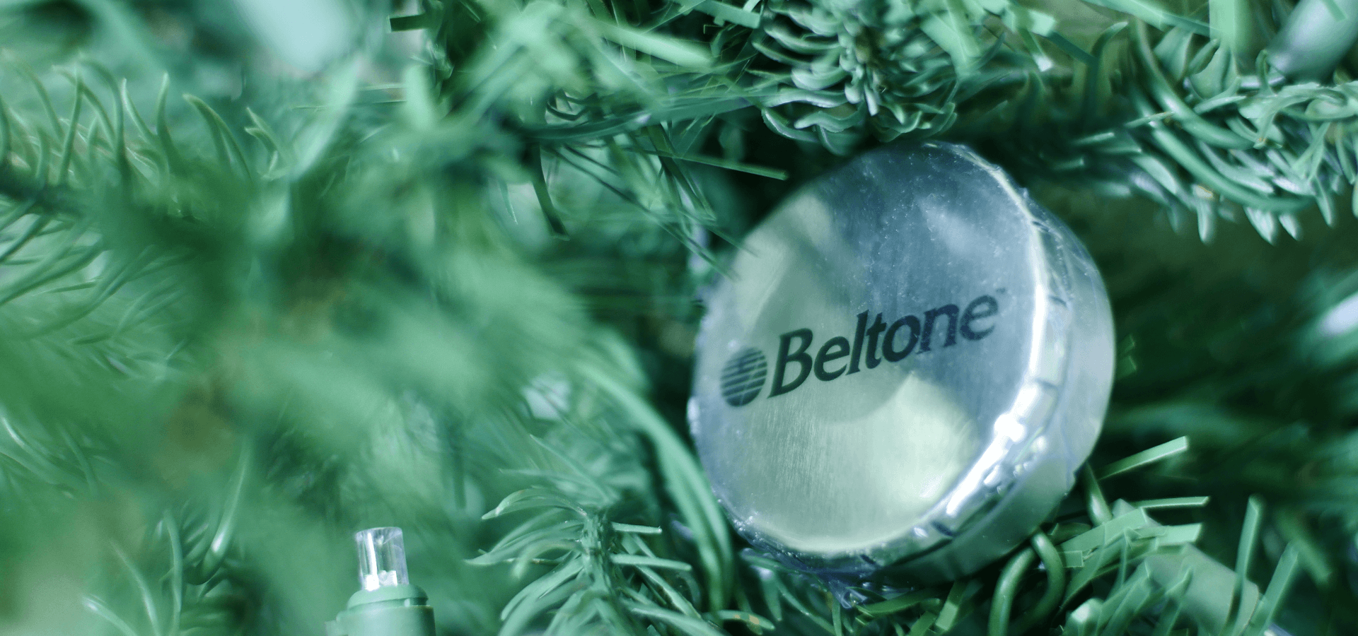 Close up picture of a Christmas truee with the Beltone logo
