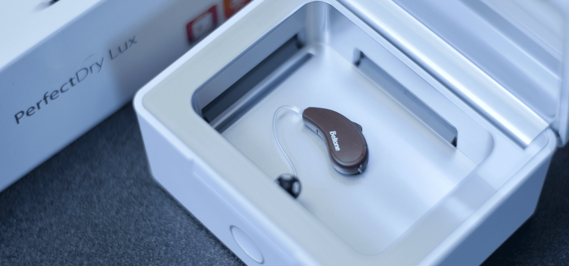 Black Beltone hearing aid inside a white box