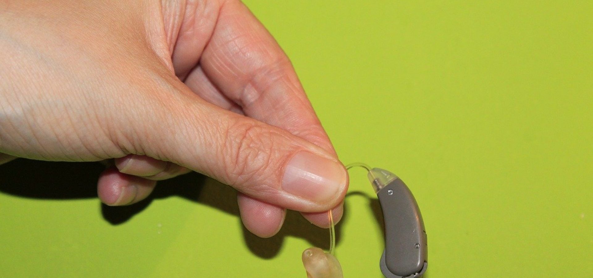 holding a hearing aid