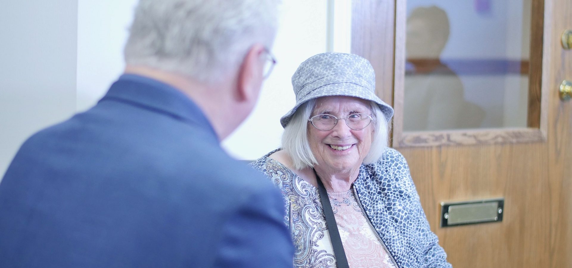 Senior woman talking with hearing aid practioner at an appointment