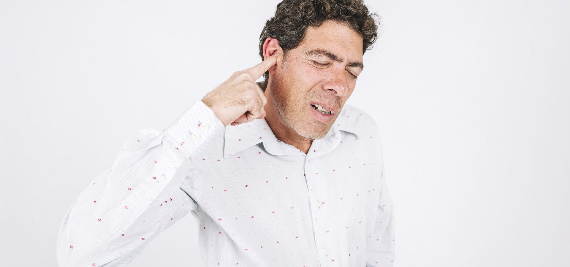 Man with hearing loss suffering from hearing recruitment